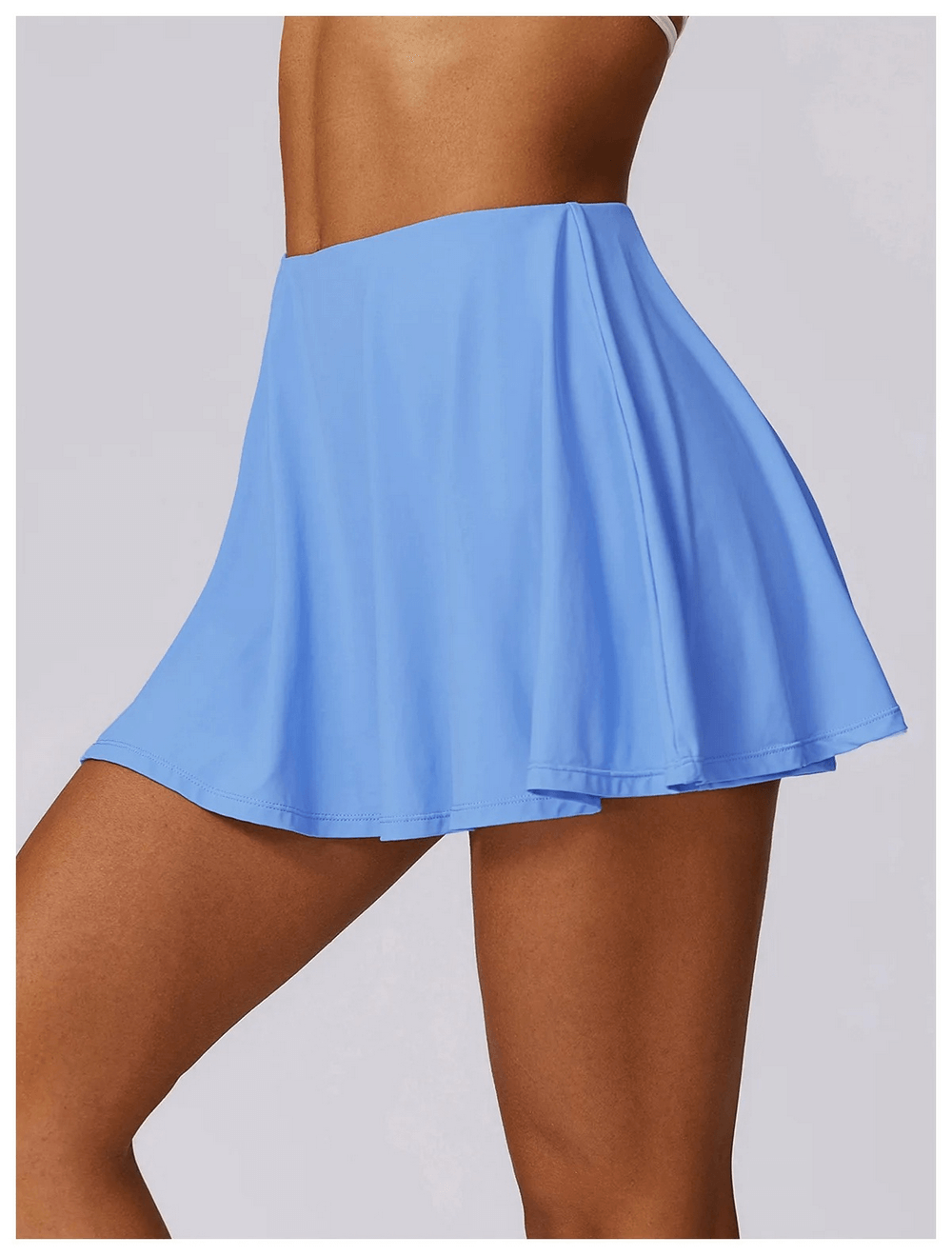 Stylish blue women's flared sports skirt for dancing and fitness, made from nylon and spandex. Ideal for active lifestyles.